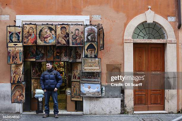 Man looks out from his shop selling religious souvenir merchandise on February 25, 2013 in Rome, Italy. The Pontiff will hold his last weekly public...