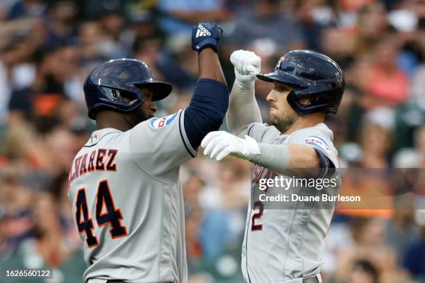 Alex Bregman of the Houston Astros celebrates with Yordan Alvarez after hitting a two-run home run against the Detroit Tigers during the fifth inning...