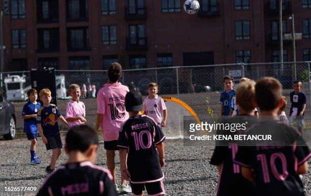 Boys play soccer as most wear Messi shirts outside the Red Bull arena ahead of the Major League Soccer 2023 match between Inter Miami and New York...