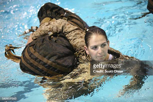 Marine recruit Chelsey Courtney of Coon Rapids, Minnesota hauls a backpack while swimming in her uniform as she is tested to determine her swimming...