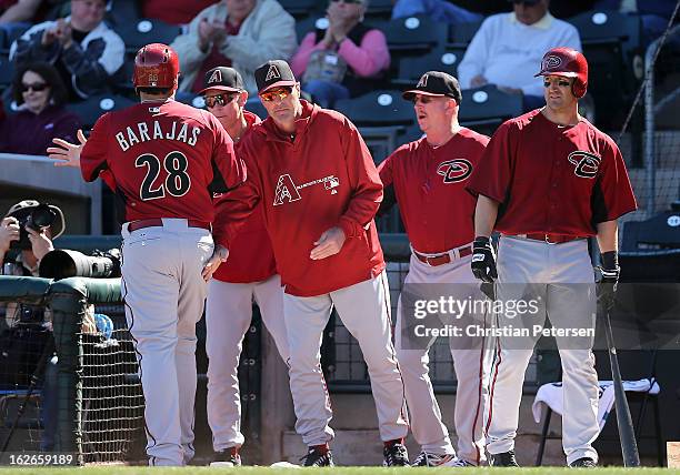 Manager Kirk Gibson and bench coach Alan Trammell of the Arizona Diamondbacks congratulate Rod Barajas after he scored a second inning run against...