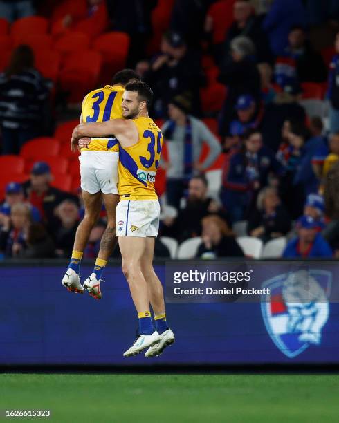 Jamaine Jones of the Eagles and Josh Rotham of the Eagles celebrate on the final siren after winning the round 23 AFL match between Western Bulldogs...