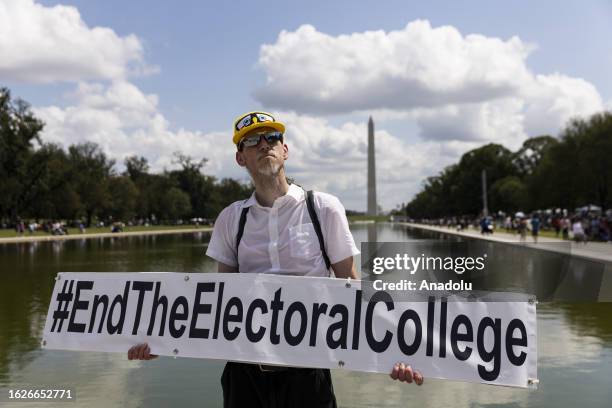 Demonstrator holds a banner on the 60th anniversary of the March On Washington and Martin Luther King Jr's historic 'I Have a Dream' speech at the...