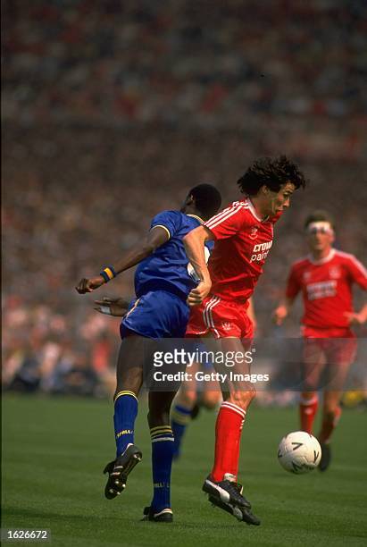 John Fashanu of Wimbledon and Alan Hansen of Liverpool struggle for possession of the ball during the FA Cup final at Wembley Stadium in London....