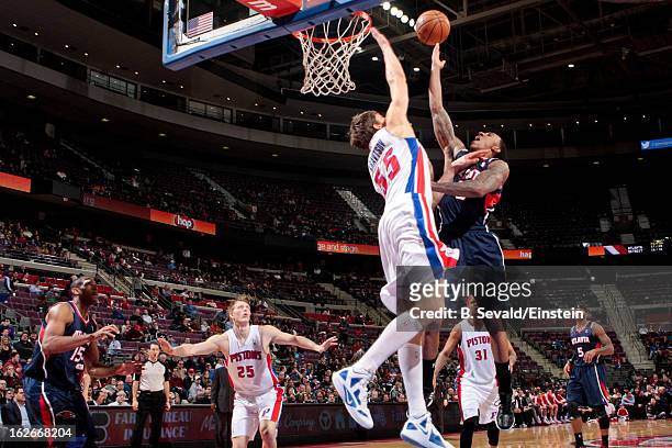 Jeff Teague of the Atlanta Hawks shoots a layup against Viacheslav Kravtsov of the Detroit Pistons on February 25, 2013 at The Palace of Auburn Hills...