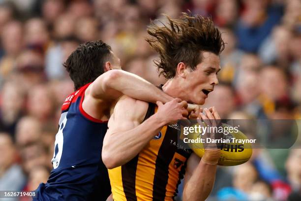 Jake Lever of the Demons takes Ned Long of the Hawks high during the round 23 AFL match between Melbourne Demons and Hawthorn Hawks at Melbourne...