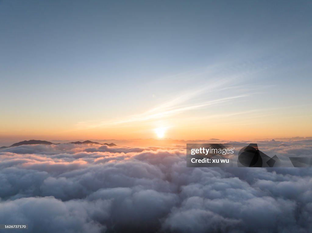 Aerial photography of sunrise over clouds