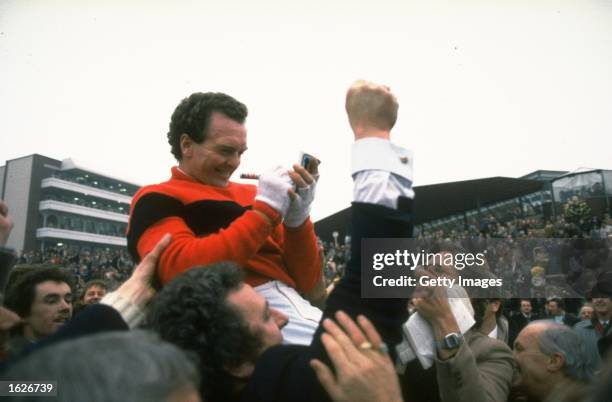 Jon Jo O''Neil of Ireland signs his autograph as he is surrounded by fans after his victory on Dawn Run in the Gold Cup at Cheltenham racecourse in...