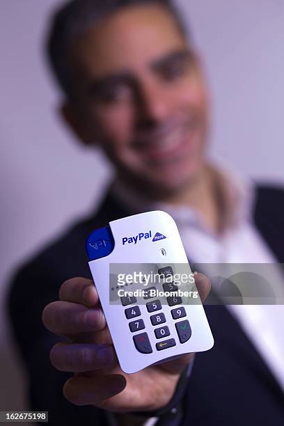 David Marcus, president of PayPal Inc. Poses for a photograph with a new chip-and-pin payment device for small businesses at the Mobile World...