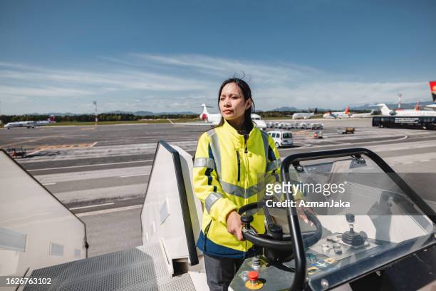 female aircraft ground worker standing at the vehicle - ground crew stock pictures, royalty-free photos & images