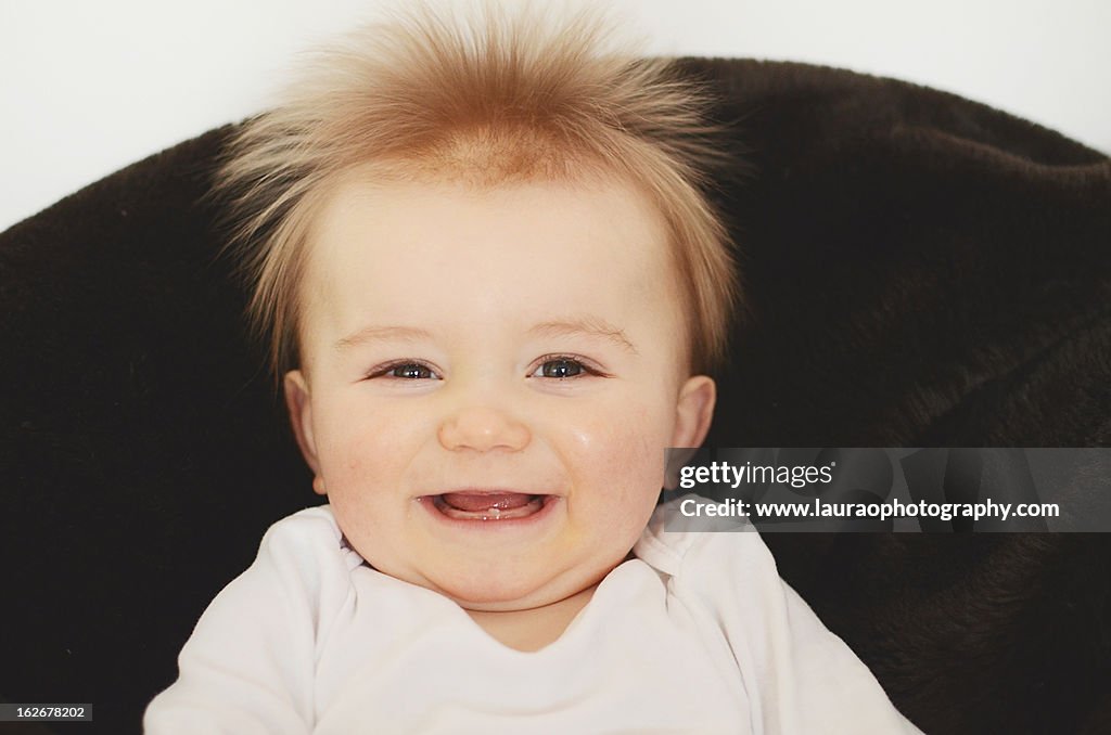 Head and shoulder shot of baby boy smiling