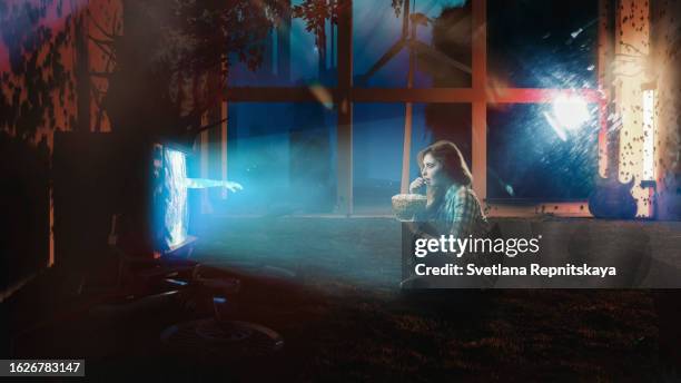 hand reaches out from the open portal of the metaverse from the tv to the girl - smart tv stock-fotos und bilder