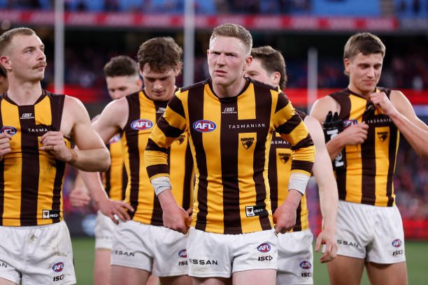 Disappointed Hawthorn players walk from the ground after the round 23 AFL match between Melbourne Demons and Hawthorn Hawks at Melbourne Cricket...