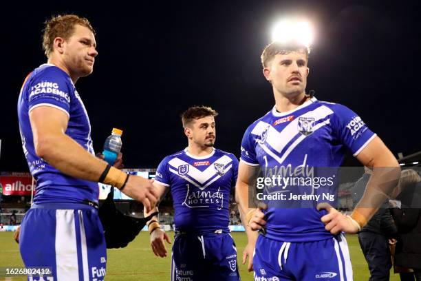 Matt Burton, Reed Mahoney and Toby Sexton of the Bulldogs react at full timeduring the round 25 NRL match between Canberra Raiders and Canterbury...