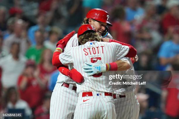 Brandon Marsh of the Philadelphia Phillies celebrates with Alec Bohm and Bryson Stott after hitting a three run home run in the bottom of the seventh...