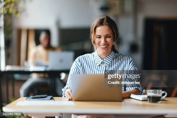 a happy beautiful blonde businesswoman working on her computer - e learning stock pictures, royalty-free photos & images