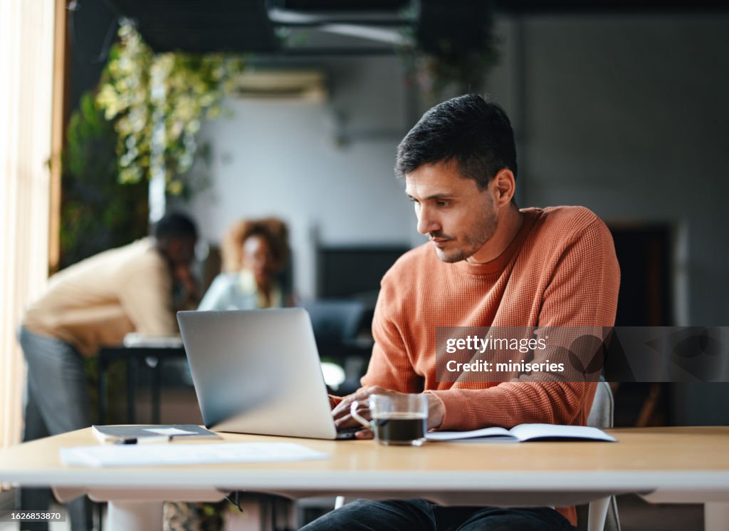 Ein fokussierter Geschäftsmann, der an seinem Computer arbeitet