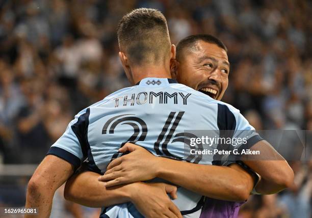 Erik Thommy of Sporting Kansas City reacts after celebrates scoring a goal with teammate Roger Espinoza in the second half against the San Jose...