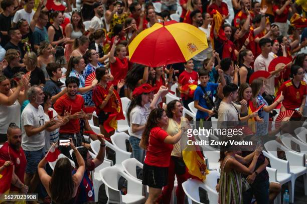 Fans of the Spanish women's soccer team react Olga Carmona's goal as they watch a broadcast on a giant screen at the Municipal Olímpics Vall d'Hebron...
