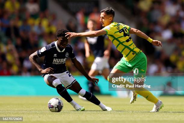 Dimitris Giannoulis of Norwich City runs with the ball whilst under pressure from Romain Esse of Millwall during the Sky Bet Championship match...