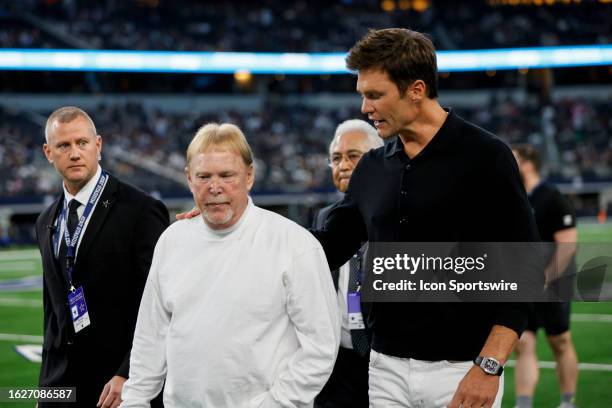 Las Vegas Raiders owner Mark Davis walks off the field with former NFL quarterback Tom Brady before the preseason game between the Dallas Cowboys and...