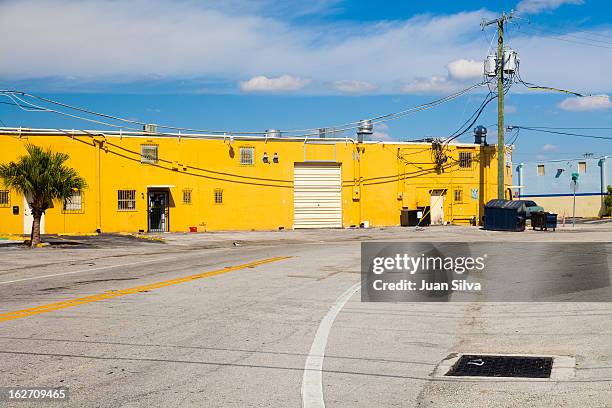 warehouse facility painted in yellow, hialeah, fl - hialeah fotografías e imágenes de stock