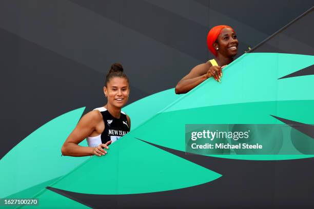 Zoe Hobbs of Team New Zealand and Shelly-Ann Fraser-Pryce of Team Jamaica react after competing in the Women's 100m Heats during day two of the World...