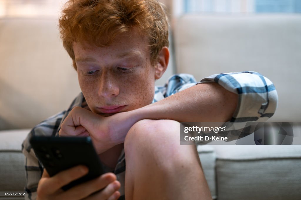 Sad boy with smart phone