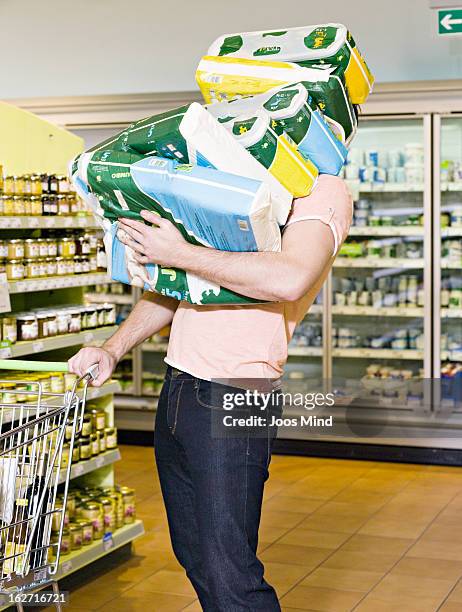 man carrying chemist`s produce in supermarket - grocery cart stock-fotos und bilder