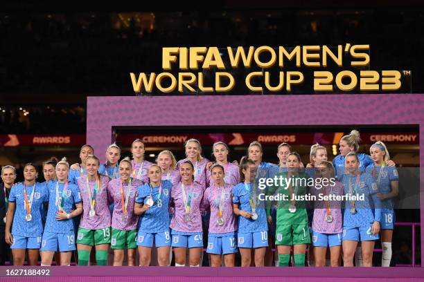 England players line up on the podium at the award ceremony followin the FIFA Women's World Cup Australia & New Zealand 2023 Final match between...