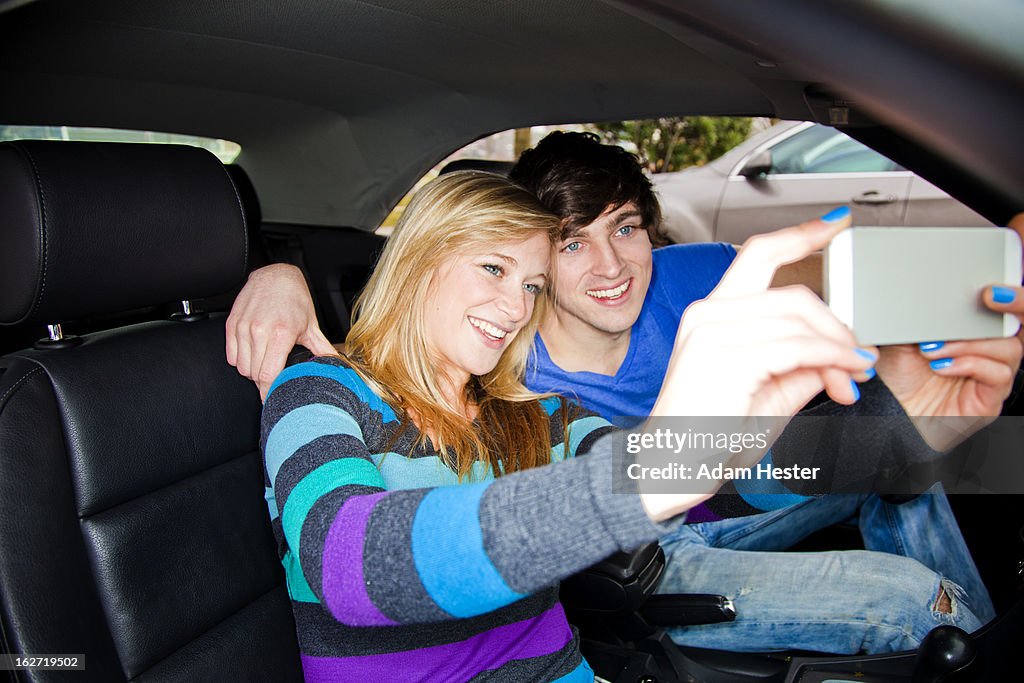 A young couple using a cell phone together