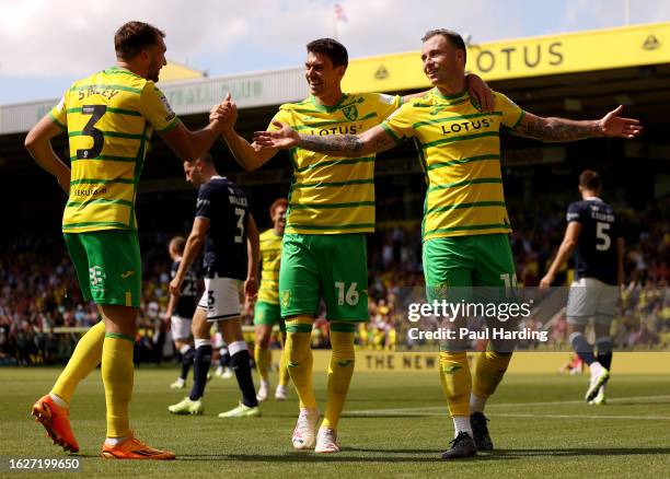 Ashley Barnes of Norwich City celebrates with teammates Jack Stacey and Christian Fassnacht after scoring the team's third goal during the Sky Bet...