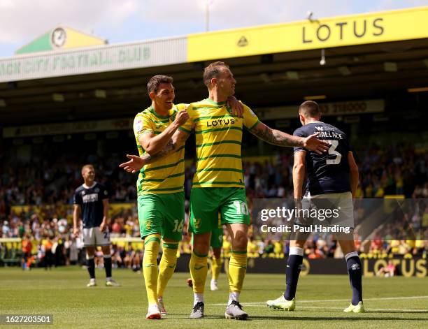 Ashley Barnes of Norwich City celebrates with teammate Christian Fassnacht after scoring the team's third goal during the Sky Bet Championship match...