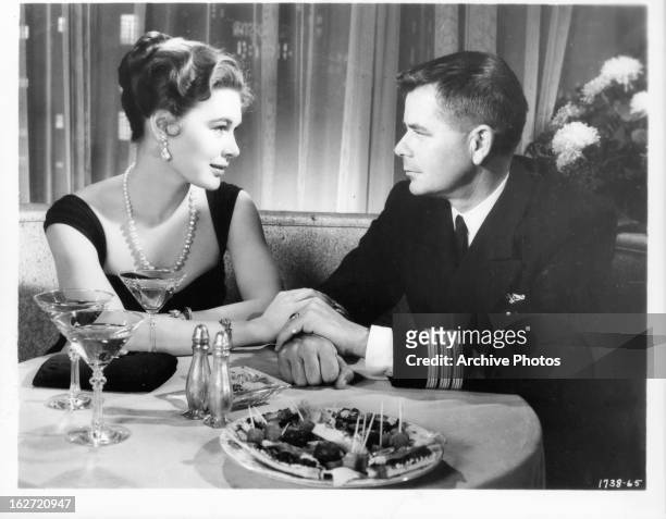 Diane Brewster having romantic evening with Glenn Ford in a scene from the film 'Torpedo Run', 1958.