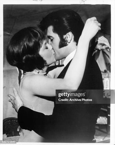 Marlyn Mason and Elvis Presley kissing in a scene from the film 'The Trouble With Girls', 1969.