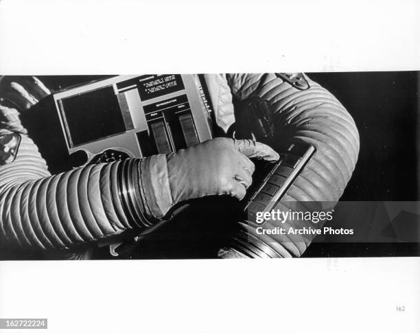 Astronaut controlling mechanisms of his suit in a scene from the film '2001: A Space Odyssey', 1968.