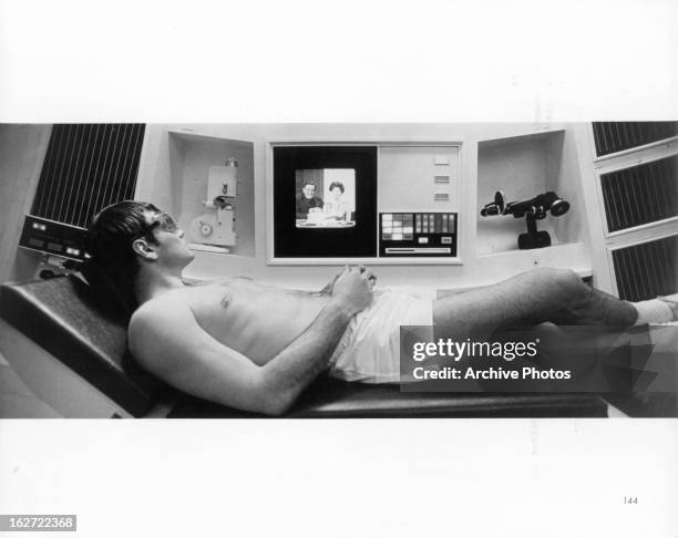 Gary Lockwood relaxes and receives sun ray treatment aboard the Discovery in a scene from the film '2001: A Space Odyssey', 1968.