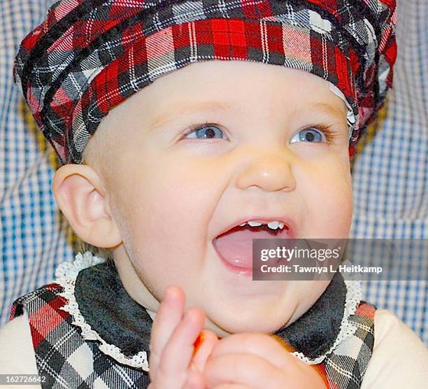 baby in red tartan plaid outfit smiles broadly - fishers indiana stock pictures, royalty-free photos & images