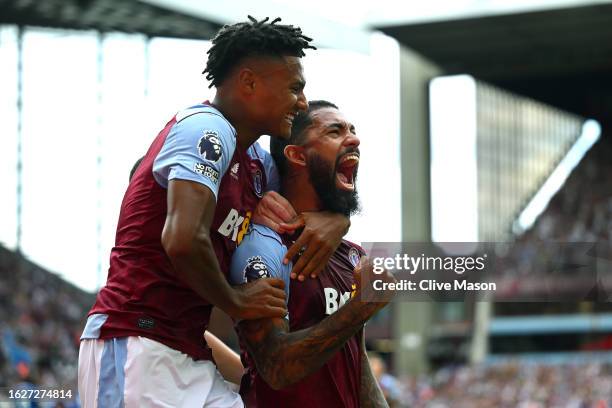 Douglas Luiz of Aston Villa celebrates with teammate Ollie Watkins after scoring the team's second goal from a penalty kick during the Premier League...