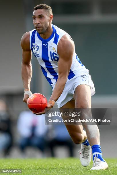 Aiden BonarÊof the Kangaroos handballs during the 2023 VFL Wildcard Round match between the Casey Demons and the North Melbourne Kangaroos at Casey...