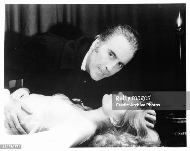 Christopher Lee about to bite Joanna Lumley in a scene from the film 'The Satanic Rites Of Dracula', 1973.
