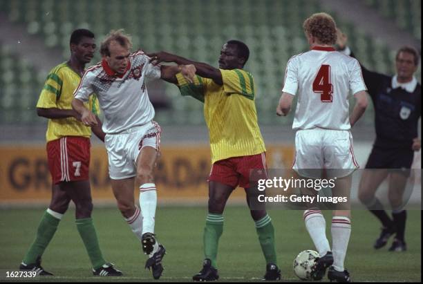 Vagiz Khidiyatullin of the Soviet Union and Roger Miller of Cameroon have a disagreement during the World Cup match in Bari, Italy. The Soviet Union...