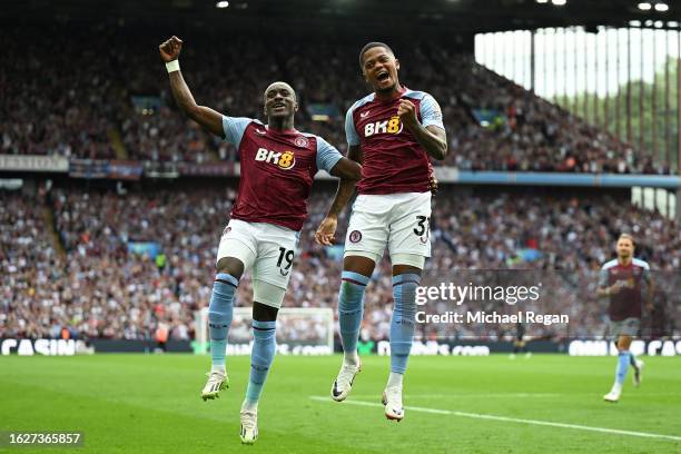 Leon Bailey of Aston Villa celebrates with teammate Moussa Diaby after scoring the team's third goal during the Premier League match between Aston...