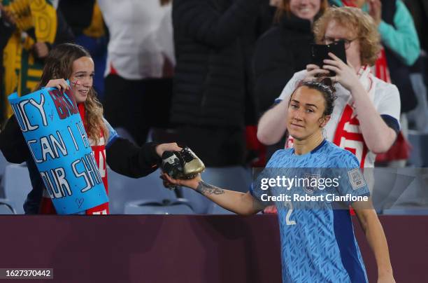 Lucy Bronze of England gives her shoes to a young fan after the team’s defeat following the FIFA Women's World Cup Australia & New Zealand 2023 Final...