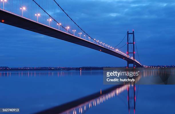 humber bridge glowing at night - kingston upon hull stock pictures, royalty-free photos & images