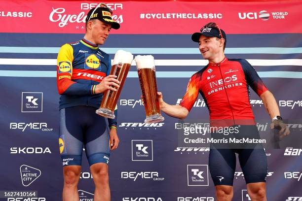Race winner Mads Pedersen of Denmark and Team Lidl-Trek and Elia Viviani of Italy and Team INEOS Grenadiers on third place celebrate with a beer on...