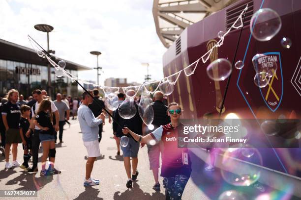 Fan of West Ham United is seen making bubbles outside the stadium prior to the Premier League match between West Ham United and Chelsea FC at London...