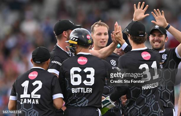 Originals bowler Tom Hartley celebrates with team mates after dismissing Tom Banton during The Hundred match between Manchester Originals Men and...