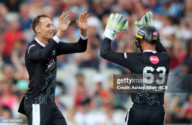 Tom Hartley and Jos Butler of Manchester Originals celebrate the wicket of Tom Banton of Northern Superchargers during The Hundred match between...