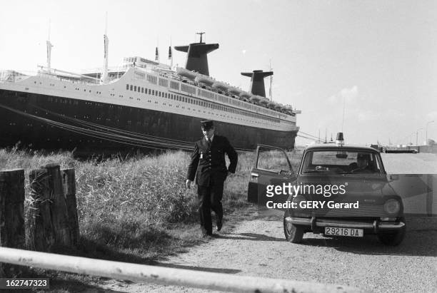 The Liner France. En octobre 1977, une voiture de police avec deux agents sur le quai du Havre ou est amarré le paquebot transatlantique le 'FRANCE'...